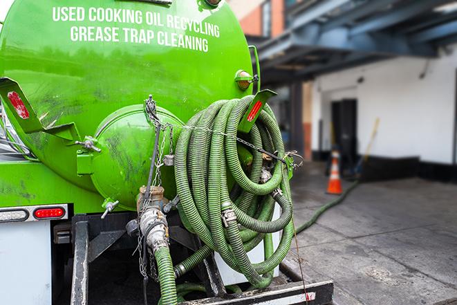 a professional technician pumping a restaurant's grease trap in Alsip, IL